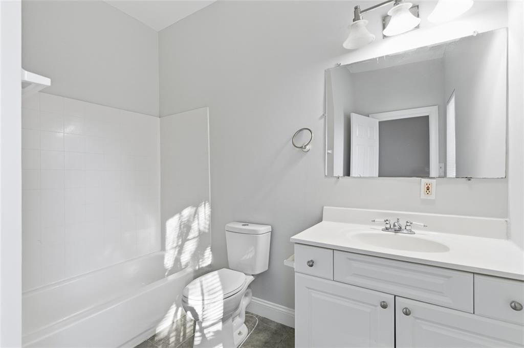 73 Atlanta Avenue Southwest Atlanta, GA 30315 - Photo 22 of 26 a bathroom with a sink mirror vanity and toilet