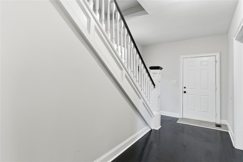 73 Atlanta Avenue Southwest Atlanta, GA 30315 - Photo 3 of 26 a view of staircase with wooden floor and white walls