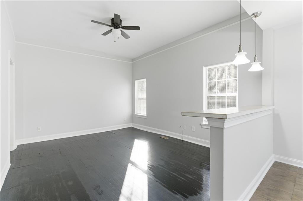 73 Atlanta Avenue Southwest Atlanta, GA 30315 - Photo 5 of 26 a view of an empty room with wooden floor and a window