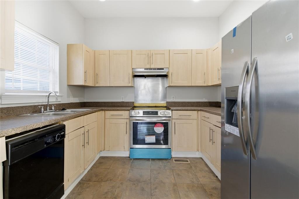 73 Atlanta Avenue Southwest Atlanta, GA 30315 - Photo 9 of 26 a kitchen with stainless steel appliances granite countertop a stove a refrigerator and a sink