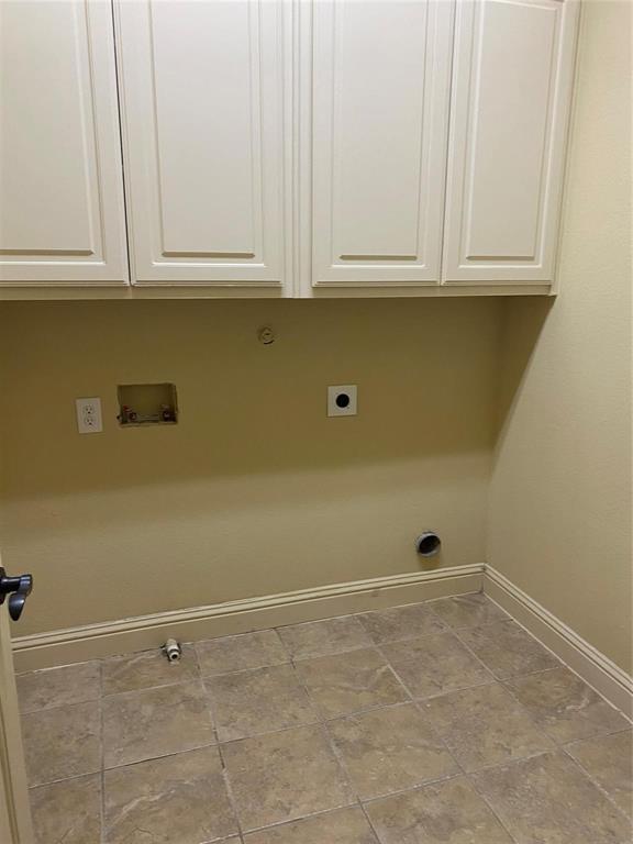 2222 Kirby Street Dallas, TX 75204 - Photo 14 of 25 Utility room featuring white shaker-style cabinetry, a neutral wall color, and square tile flooring
