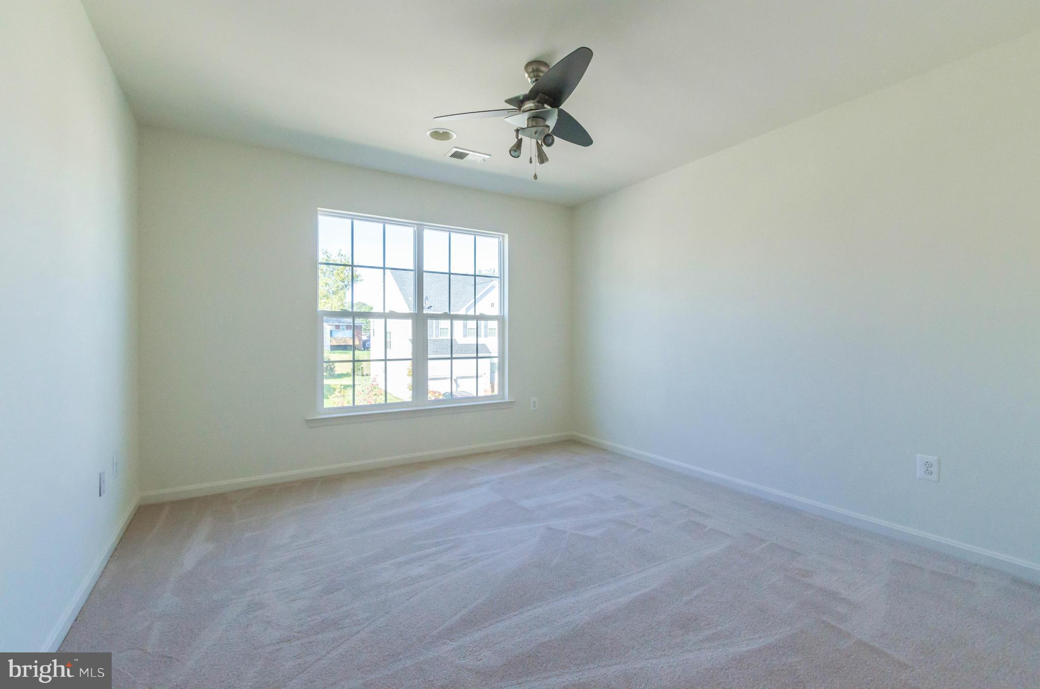 6517 Clarington Road Baltimore, MD 21209 - Photo 19 of 30 an empty room with a window and a ceiling fan