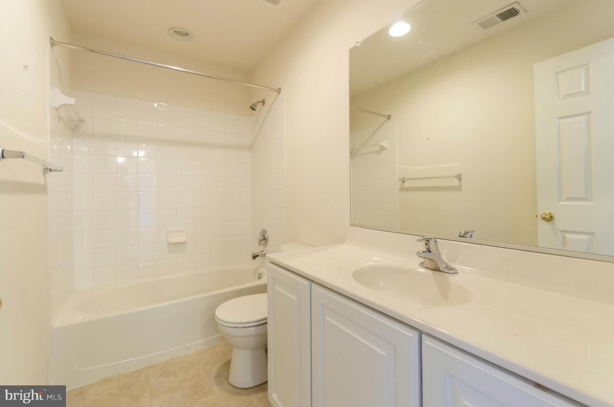 6517 Clarington Road Baltimore, MD 21209 - Photo 21 of 30 a bathroom with a sink a toilet and shower