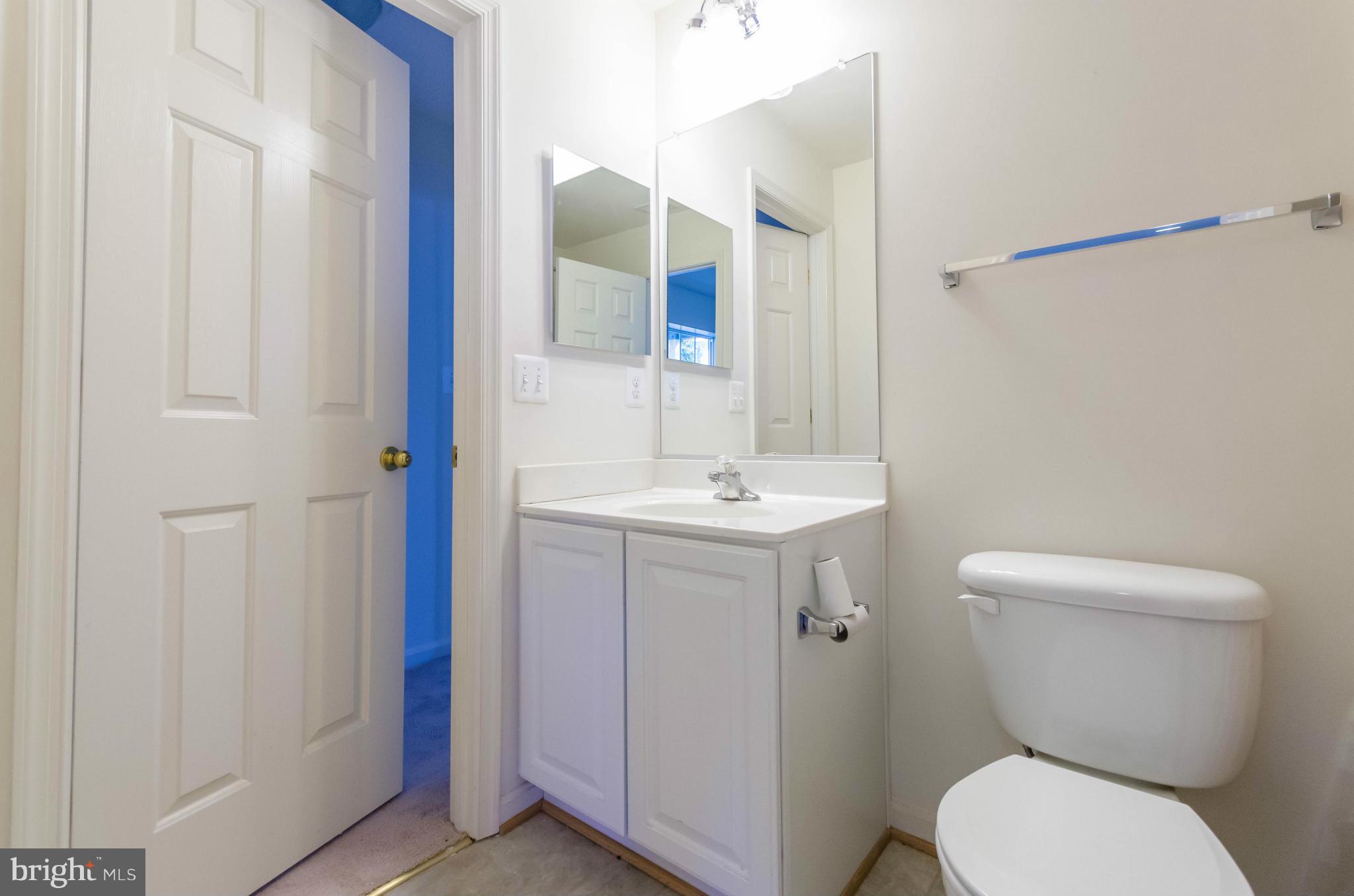 6517 Clarington Road Baltimore, MD 21209 - Photo 23 of 30 a bathroom with a toilet sink and mirror