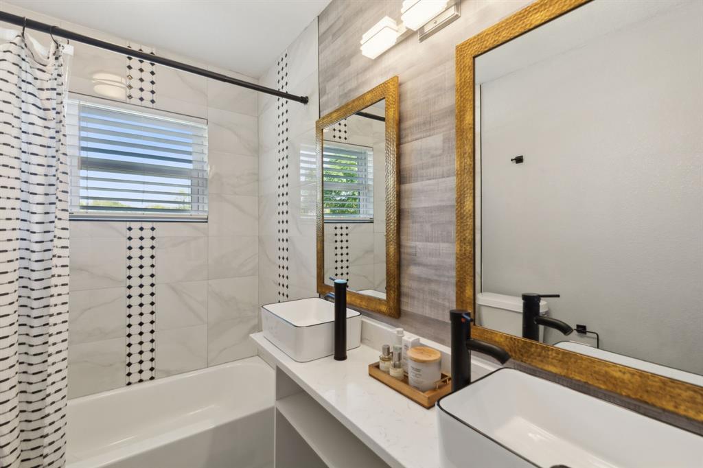 2630 Springvale Drive Farmers Branch, TX 75234 - Photo 19 of 25 a bathroom with a bathtub and a shower