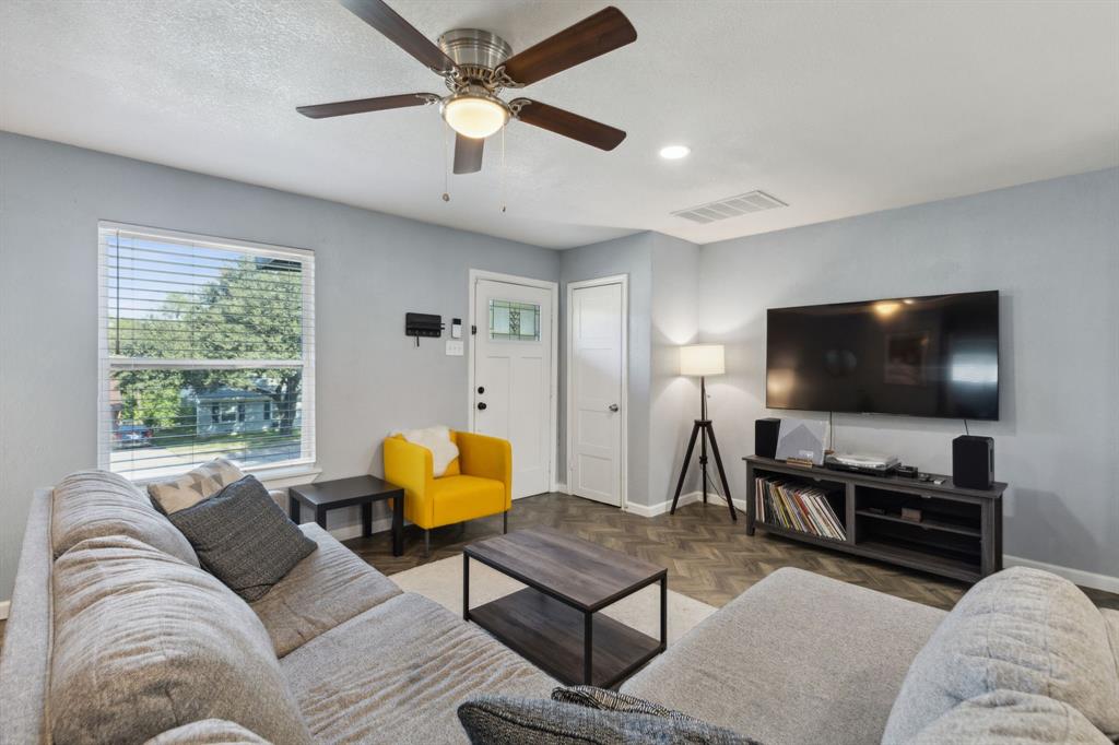 2630 Springvale Drive Farmers Branch, TX 75234 - Photo 4 of 25 a living room with furniture and a flat screen tv