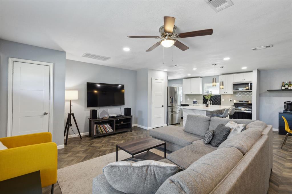 2630 Springvale Drive Farmers Branch, TX 75234 - Photo 5 of 25 a living room with furniture and a flat screen tv