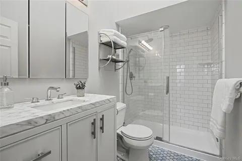 a bathroom with a sink toilet and shower