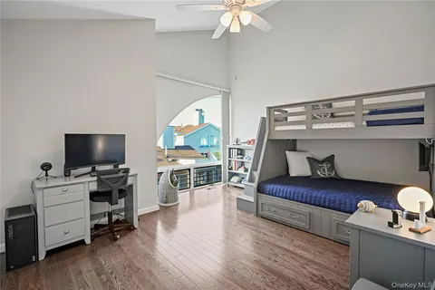 a bedroom with furniture and a flat screen tv