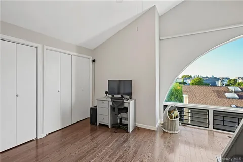 a view of a workspace with furniture and wooden floor