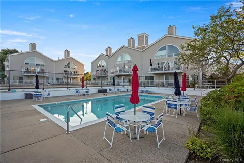 a view of a house with swimming pool and sitting area