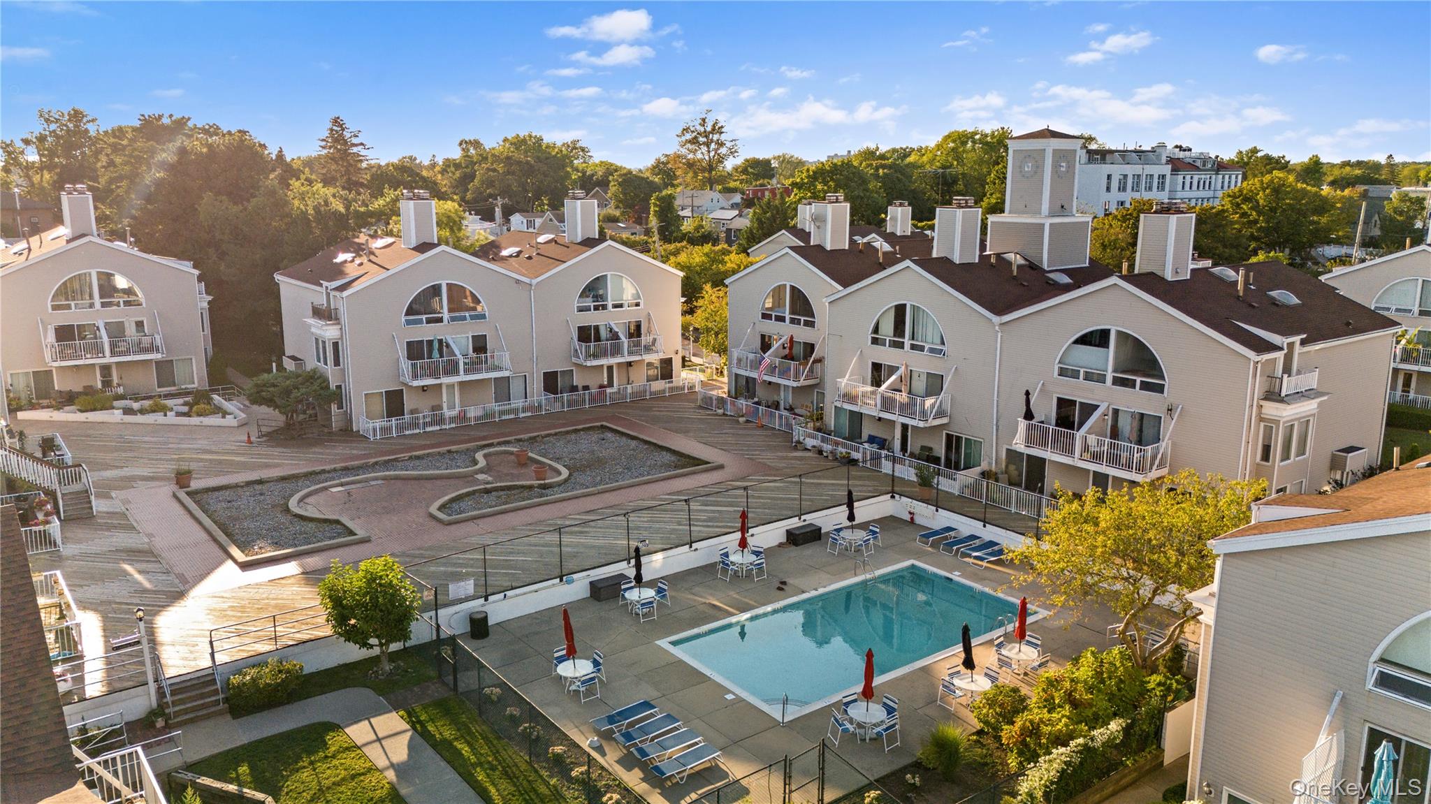 21 Deepwater Way Bronx, NY 10464 - Photo 20 of 27 a view of a white house with a big yard plants and large tree