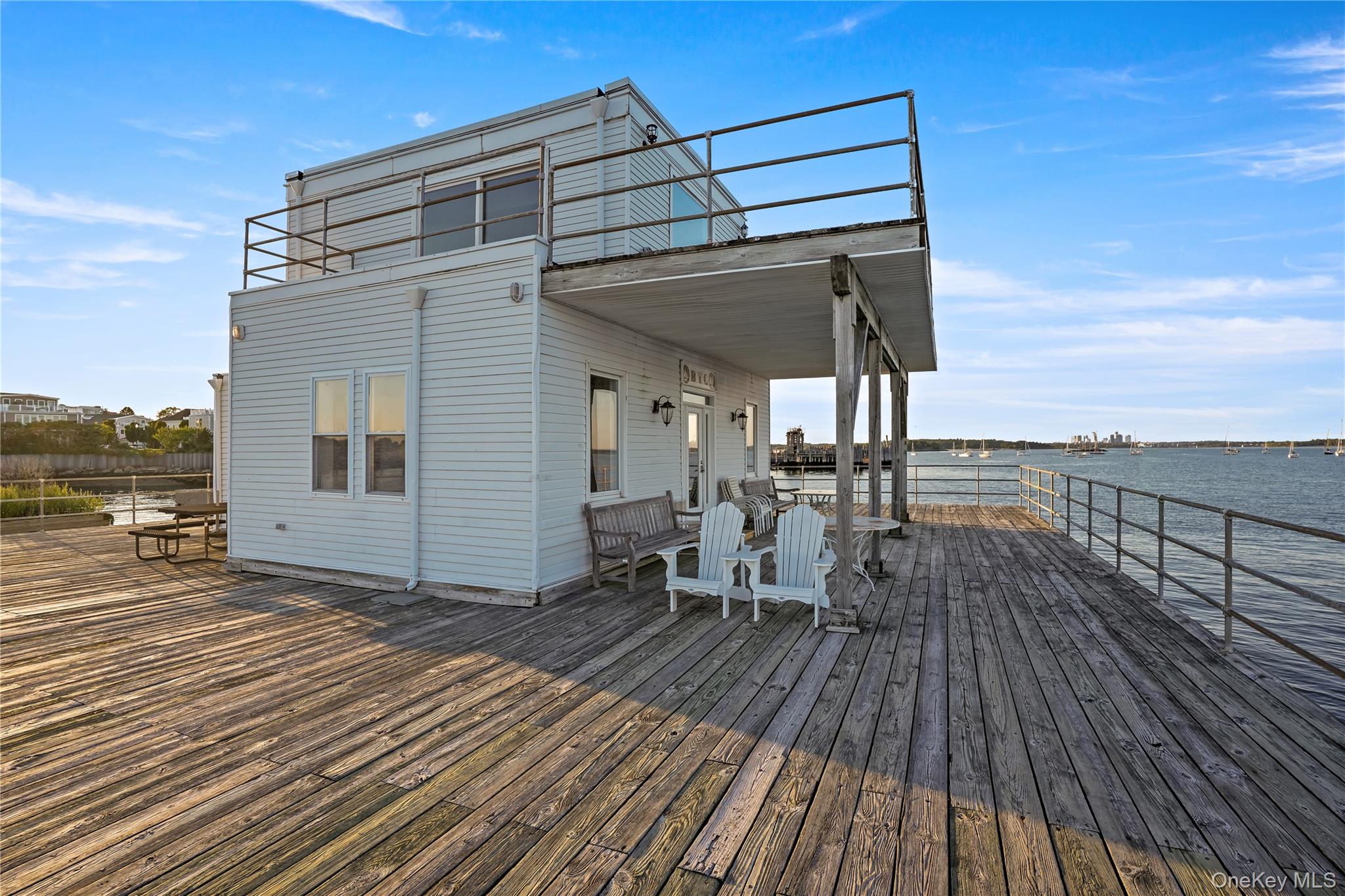 21 Deepwater Way Bronx, NY 10464 - Photo 22 of 27 a view of a balcony with chairs and wooden floor