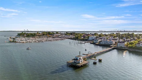 a view of a lake with boats and trees in the background