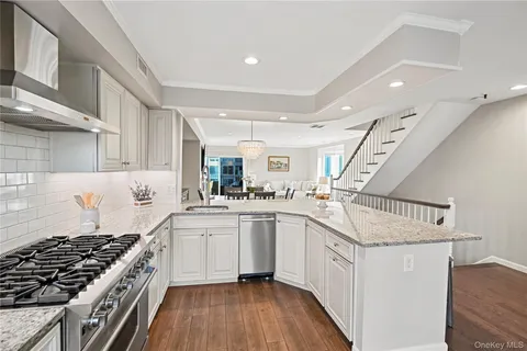 a kitchen with white cabinets and appliances