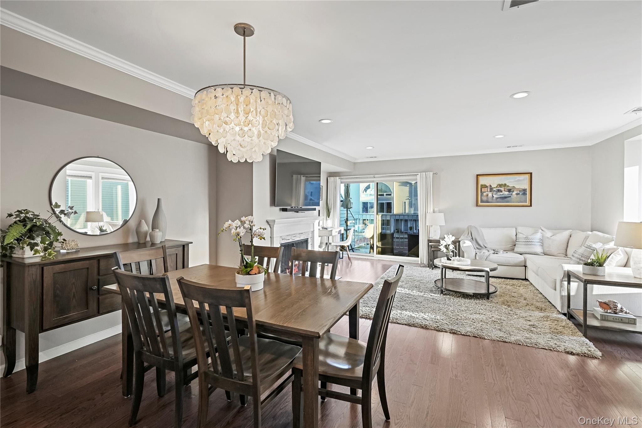 21 Deepwater Way Bronx, NY 10464 - Photo 6 of 27 a dining room with furniture a chandelier and wooden floor