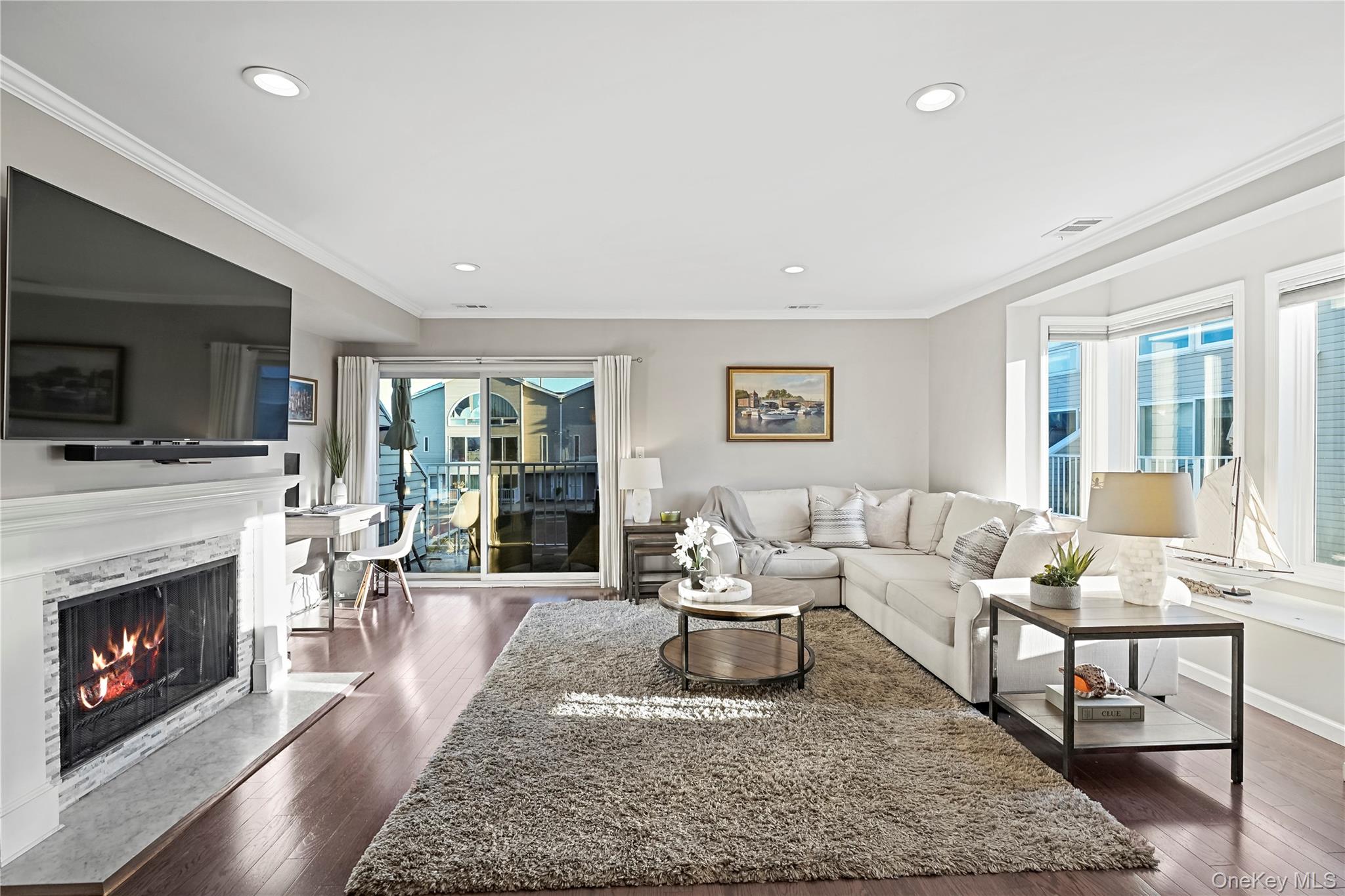 21 Deepwater Way Bronx, NY 10464 - Photo 7 of 27 a living room with furniture and a fireplace