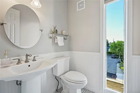 a bathroom with a sink mirror and toilet