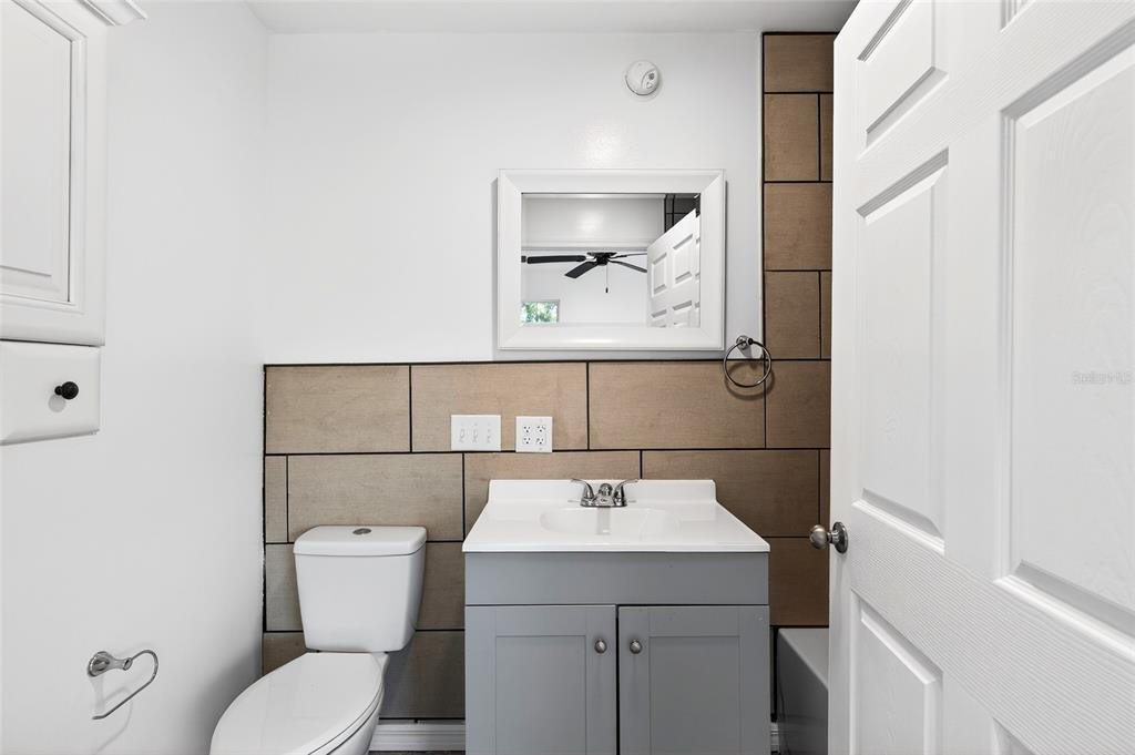 1110 Southwest Fort King Street Ocala, FL 34471 - Photo 13 of 30 a bathroom with a toilet sink and mirror