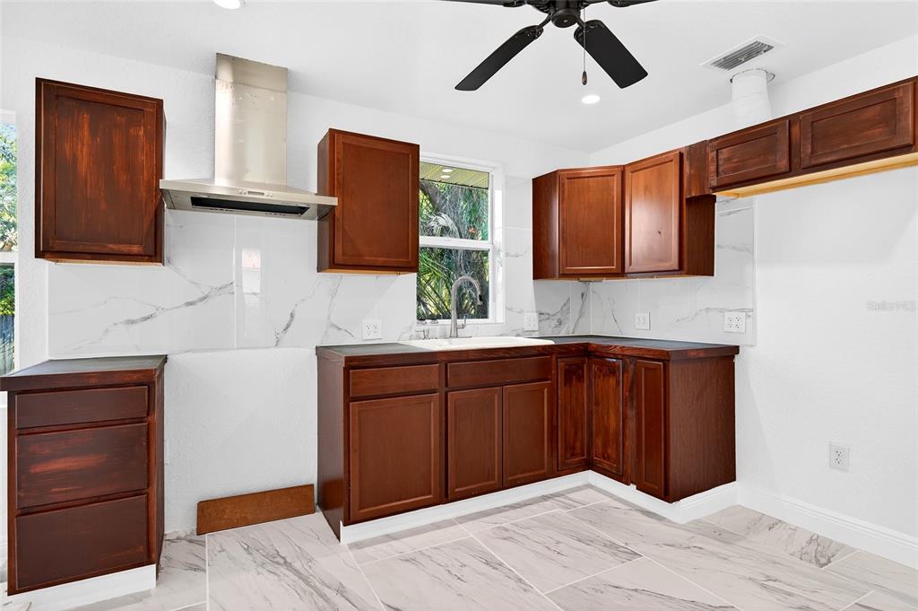 1110 Southwest Fort King Street Ocala, FL 34471 - Photo 16 of 30 a kitchen with a refrigerator and cabinets