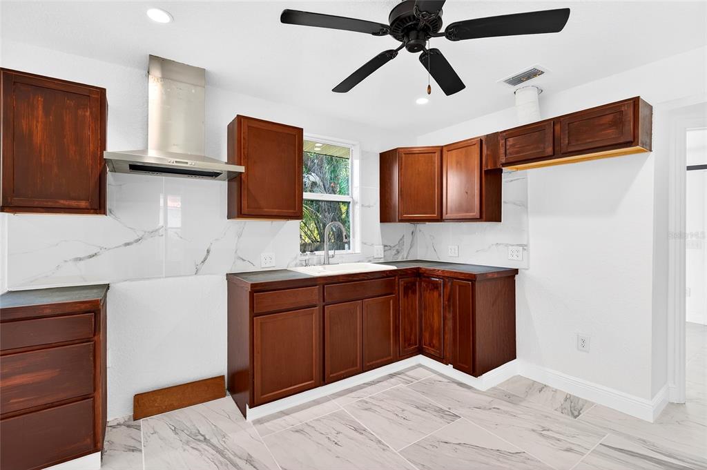1110 Southwest Fort King Street Ocala, FL 34471 - Photo 18 of 30 a kitchen with stainless steel appliances granite countertop a refrigerator and a sink