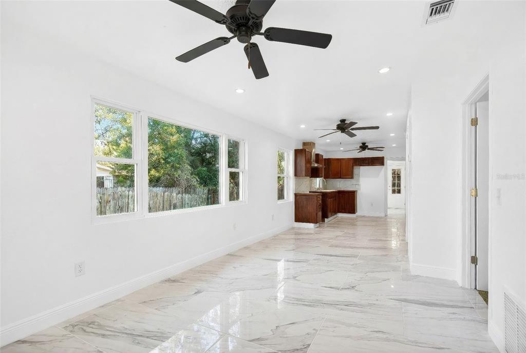 1110 Southwest Fort King Street Ocala, FL 34471 - Photo 5 of 30 an empty room with windows and ceiling fan view
