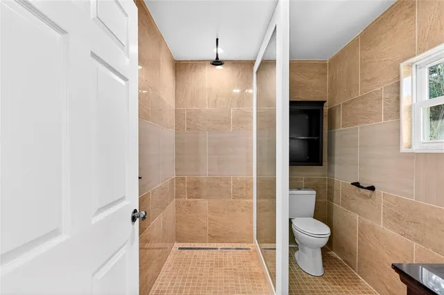 a bathroom with a shower and a toilet