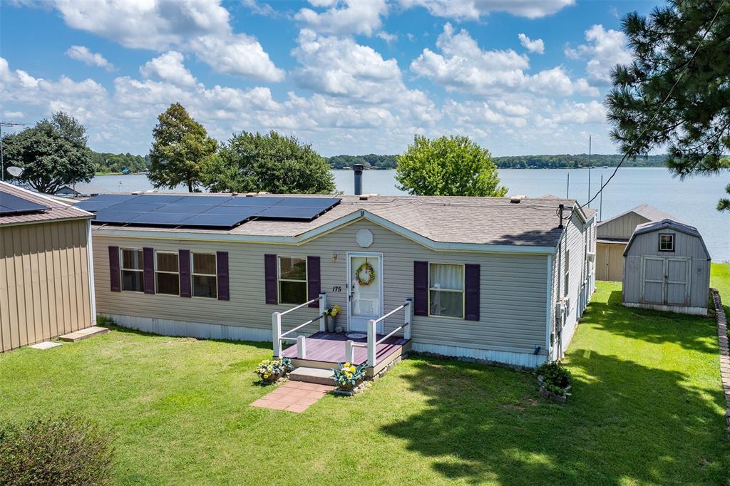 a view of a house with a backyard and a patio