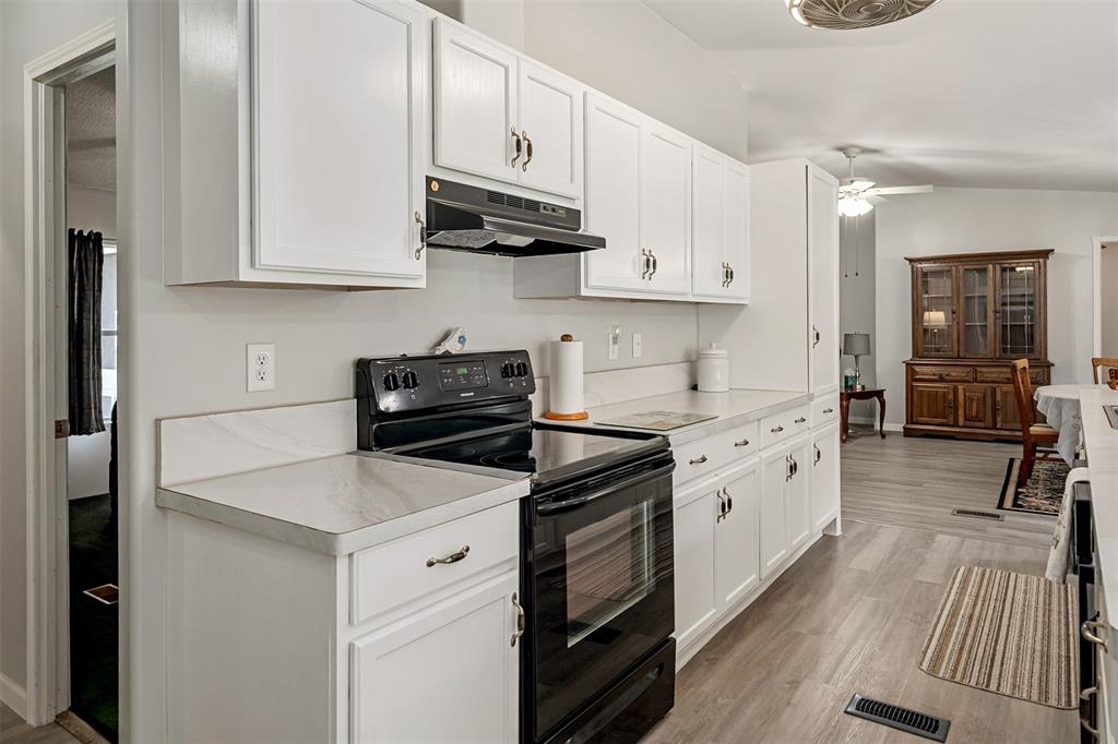 175 Kings Row Malakoff, TX 75148 - Photo 9 of 38 a kitchen with cabinets appliances a sink and a counter space