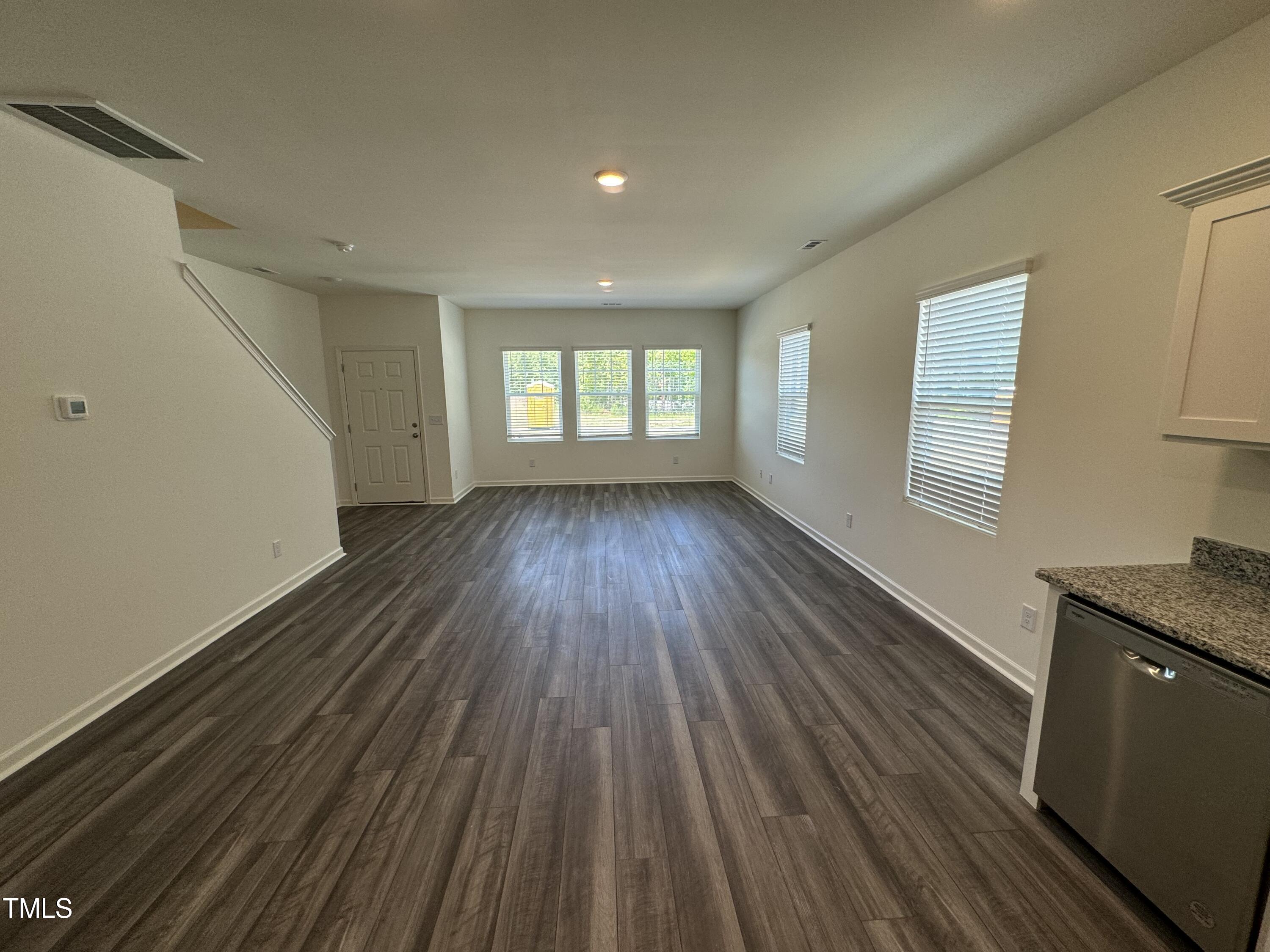 2000 Gln Xing Drive Durham, NC 27704 - Photo 9 of 18 a view of an empty room with wooden floor and a window