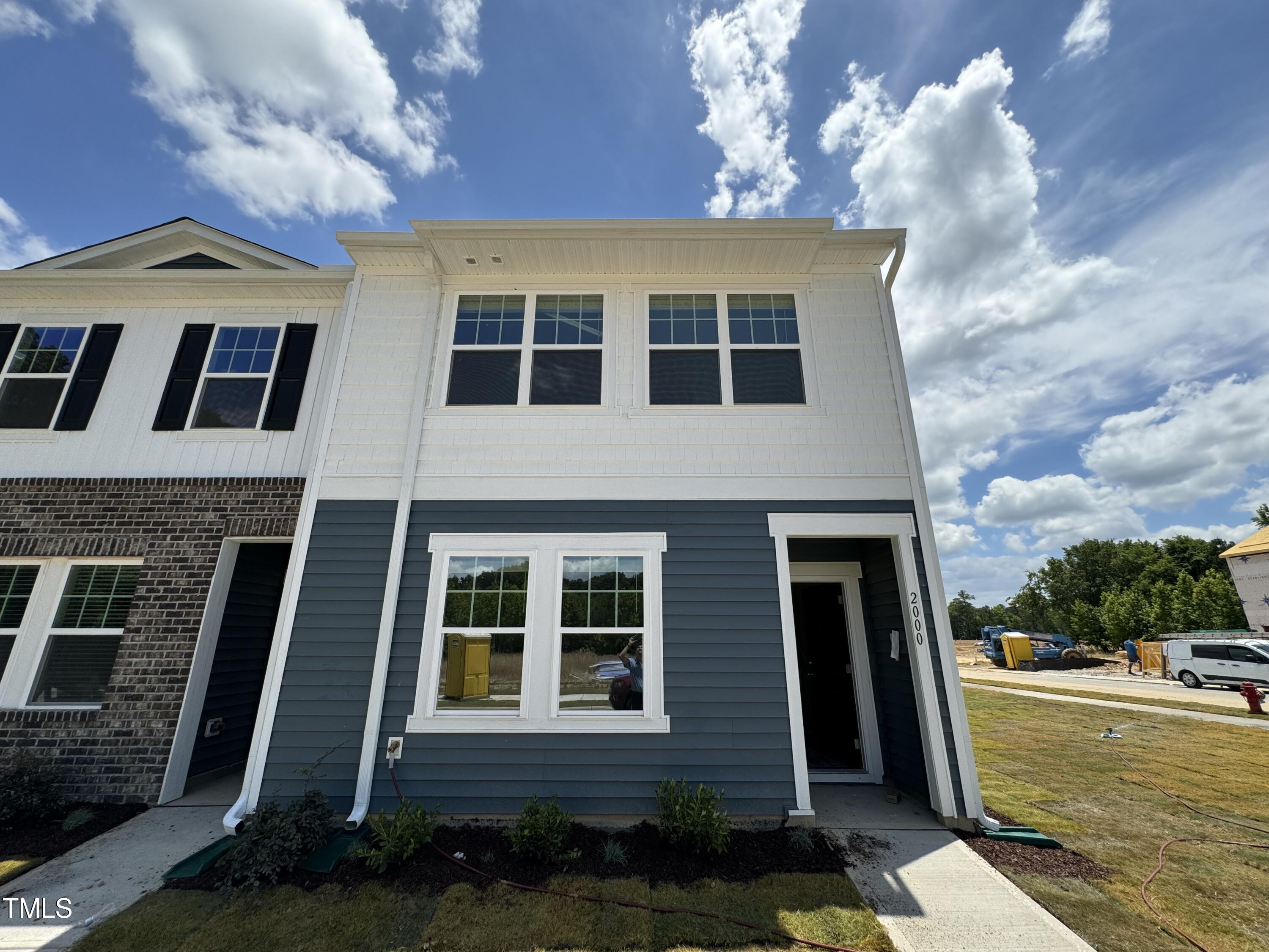 2000 Gln Xing Drive Durham, NC 27704 - Photo 2 of 18 a view of a large building next to a yard