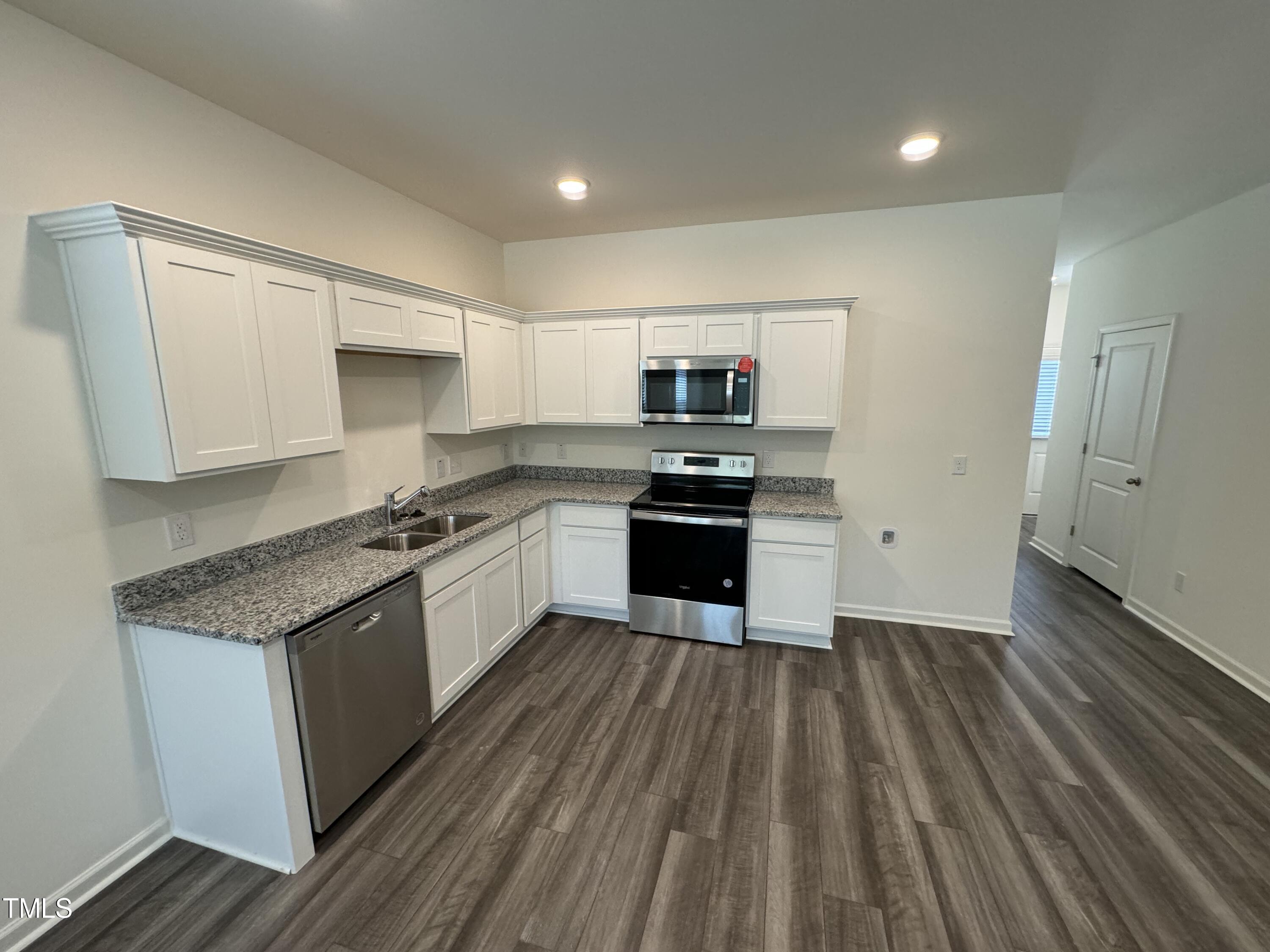 2000 Gln Xing Drive Durham, NC 27704 - Photo 8 of 18 a large kitchen with white cabinets stainless steel appliances
