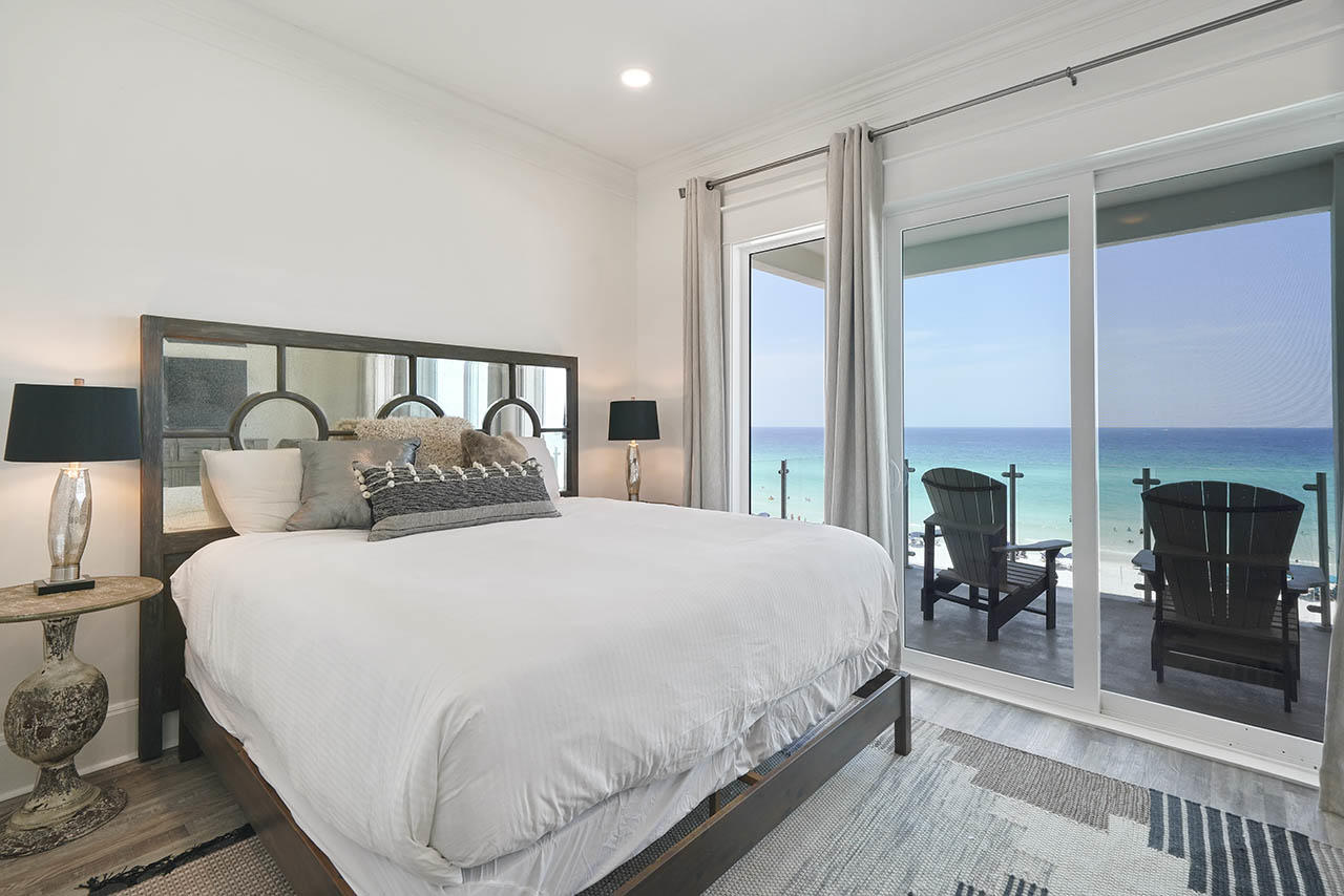 132 Sandprint Circle Destin, FL 32541 - Photo 37 of 117 a large bed sitting in a bedroom next to a fireplace