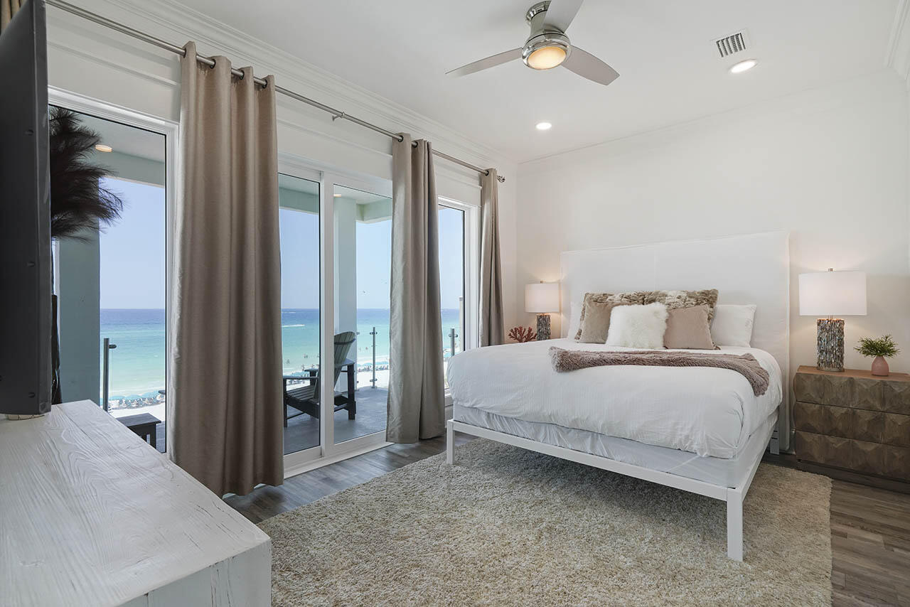 132 Sandprint Circle Destin, FL 32541 - Photo 39 of 117 a bedroom with a large bed and a chandelier