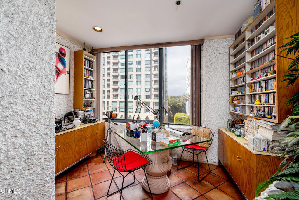 10724 Wilshire Boulevard, Unit 607 Los Angeles, CA 90024 - Photo 22 of 33 a living room with furniture and large windows