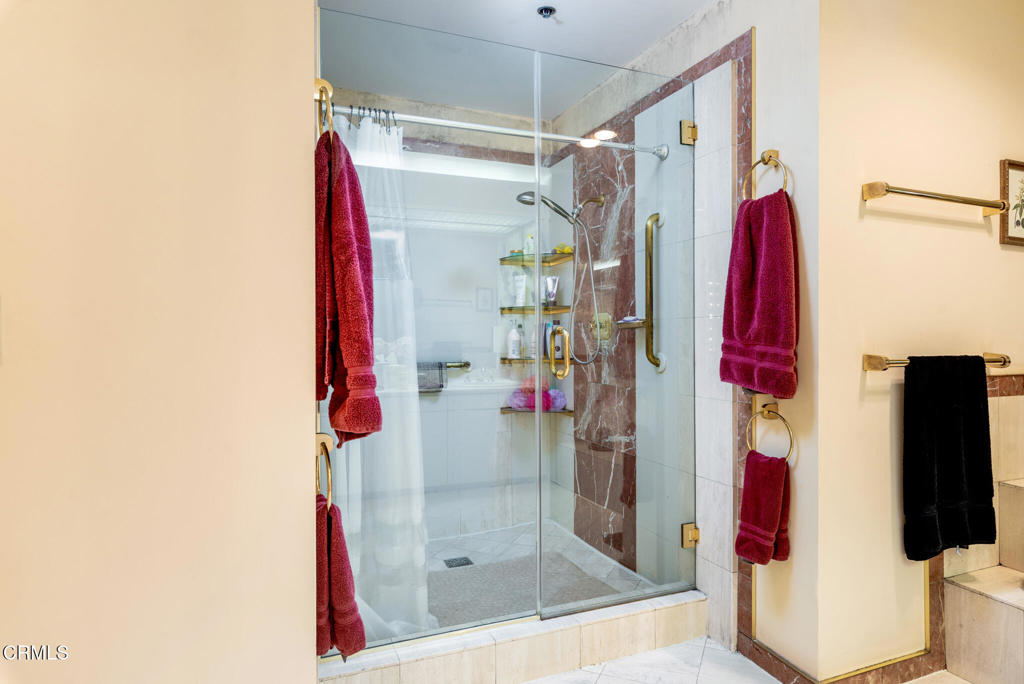 10724 Wilshire Boulevard, Unit 607 Los Angeles, CA 90024 - Photo 26 of 33 a view of walk in closet with clothes and shoes