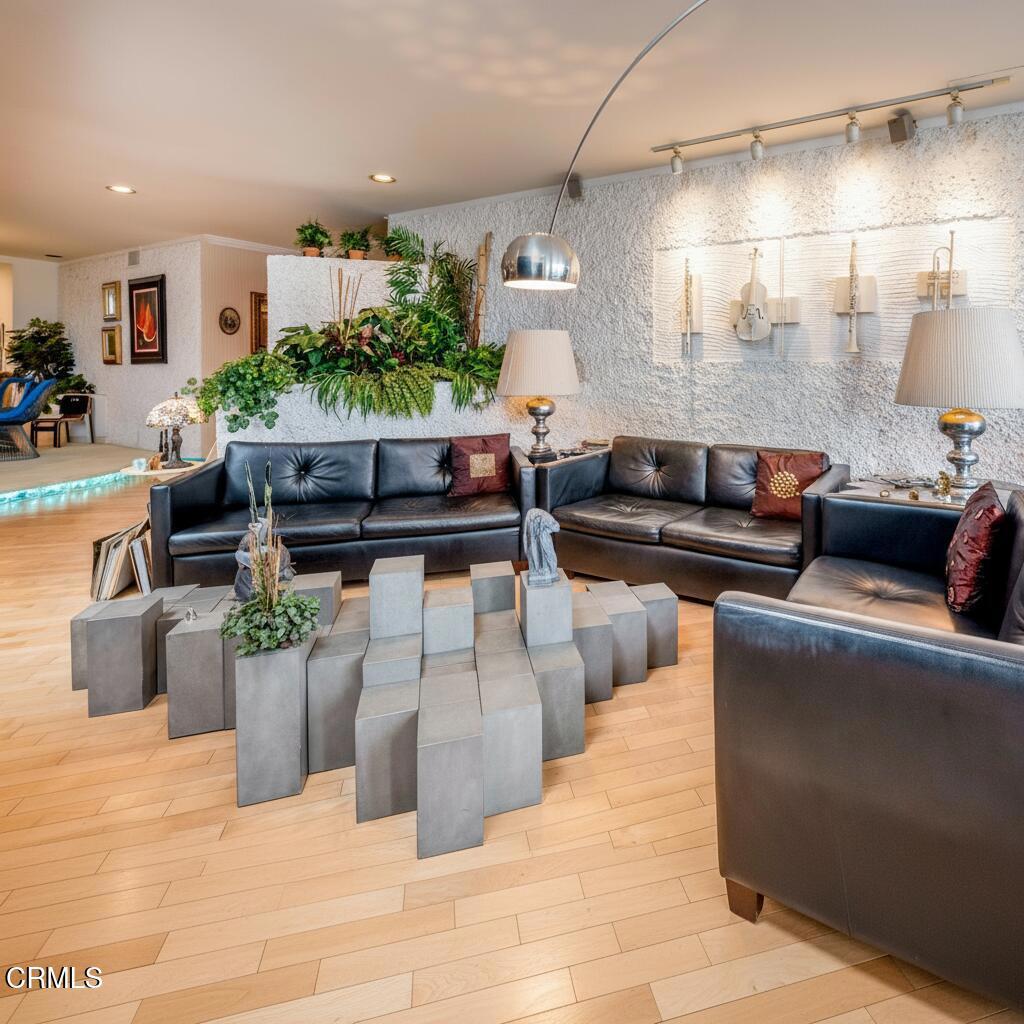 10724 Wilshire Boulevard, Unit 607 Los Angeles, CA 90024 - Photo 3 of 33 a living room with furniture and a potted plant