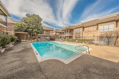 a view of yard with swimming pool and seating