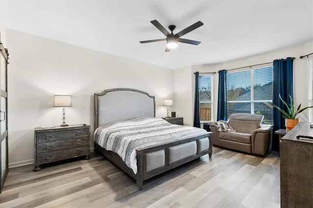 a bedroom with a bed a window and a couch