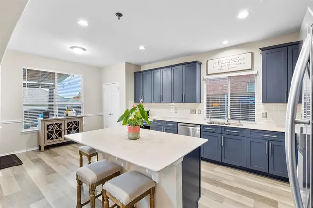 a kitchen with a stove a sink a dining table and chairs