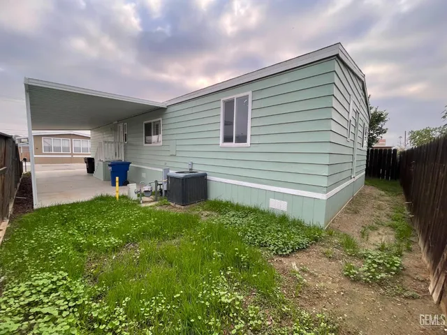 a backyard of a house with table and chairs