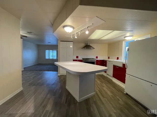 a kitchen with a sink and a stove top oven