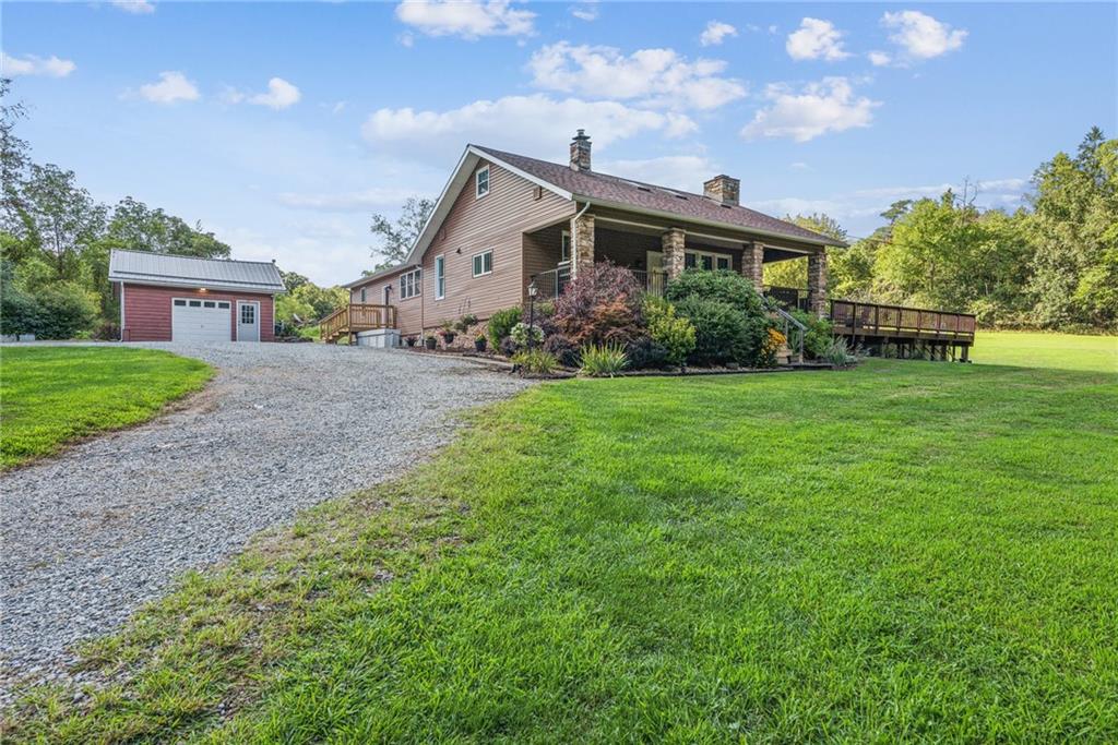 1239 New Stanton Ruffsdale Road Ruffs Dale, PA 15679 - Photo 1 of 47 a front view of a house with garden