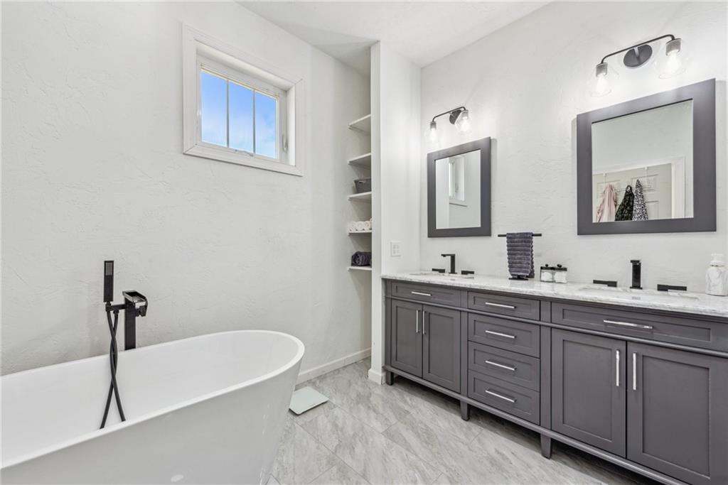 1239 New Stanton Ruffsdale Road Ruffs Dale, PA 15679 - Photo 17 of 47 a bathroom with a tub a sink and mirror