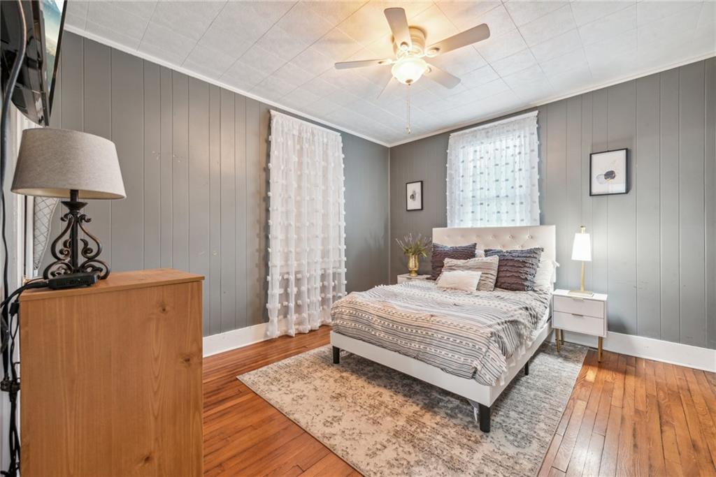 1239 New Stanton Ruffsdale Road Ruffs Dale, PA 15679 - Photo 22 of 47 a bedroom with a bed chandelier and a window