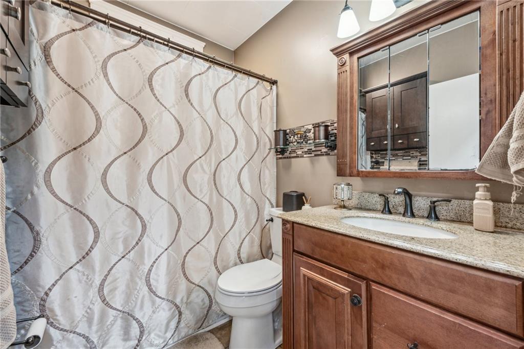 1239 New Stanton Ruffsdale Road Ruffs Dale, PA 15679 - Photo 23 of 47 a bathroom with a sink vanity mirror and toilet