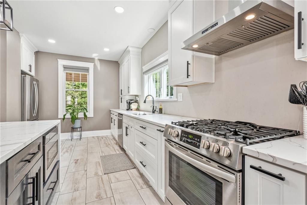 1239 New Stanton Ruffsdale Road Ruffs Dale, PA 15679 - Photo 5 of 47 a kitchen with stainless steel appliances a sink stove and cabinets