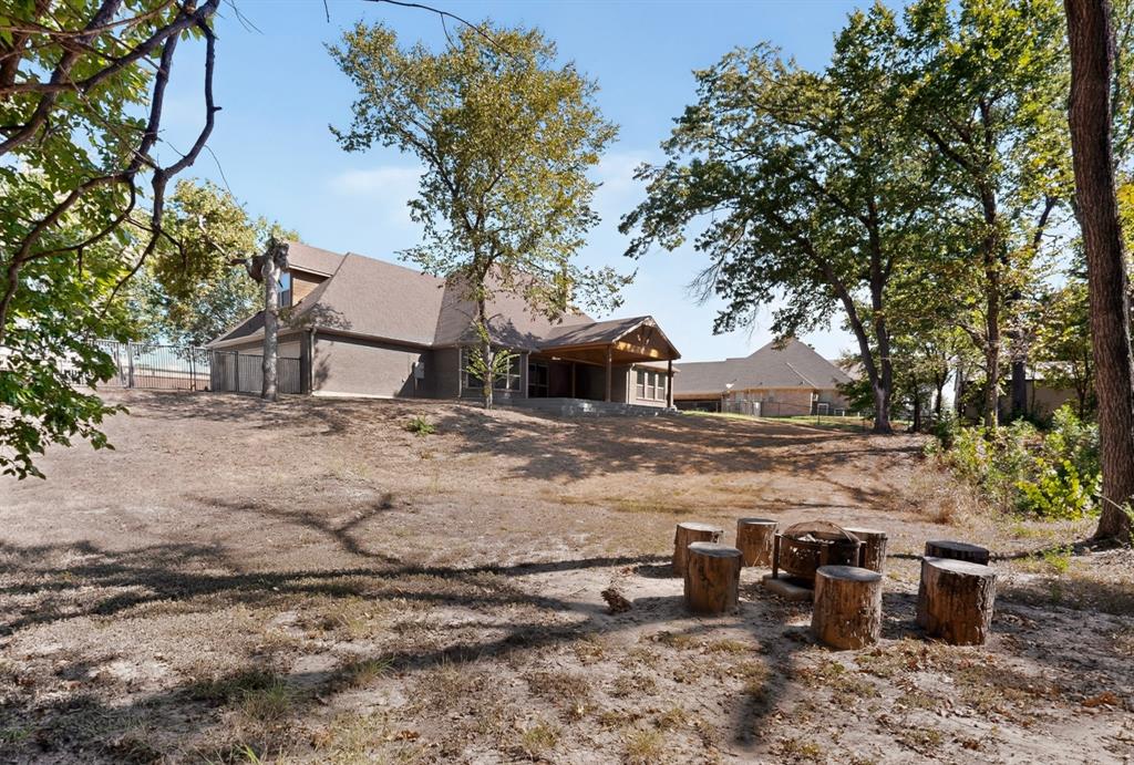 108 Winding Way Azle, TX 76020 - Photo 36 of 38 outdoor privacy on over 1.3 acres with a firepit sitting area outback.