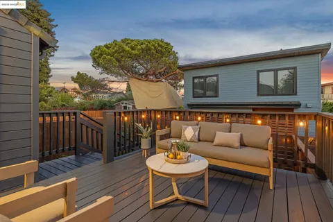 a view of a deck with a chair and a potted plant