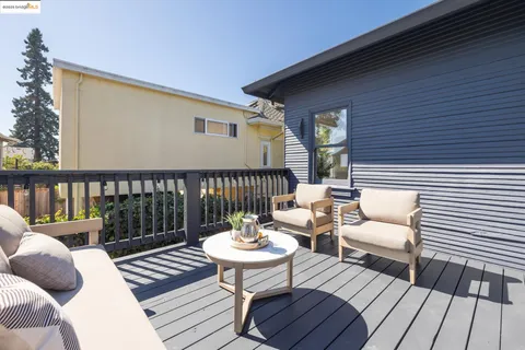 a view of a house with backyard and deck